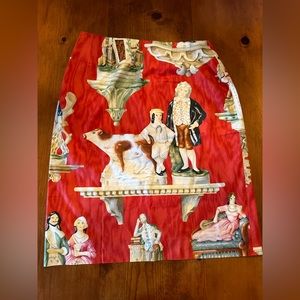 Vintage Steven Stolman pencil skirt red with Victorian Staffordshire figurines.
